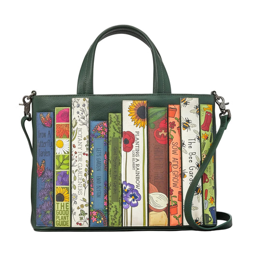 Handbag with book-themed design on a white background